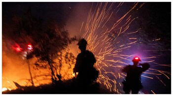 The wind whips embers while firefighters battle the fire in the Angeles National Forest near Mt. Wilson as the wildfires burn in the Los Angeles area. (Courtesy: Reuters photo)