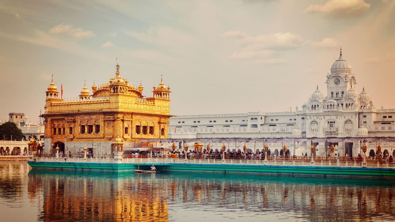 2. Amritsar Known for its rich cultural heritage, Amritsar is also home to mouthwatering Punjabi cuisine. Indulge in Amritsari kulcha with dollops of butter, savor the traditional sarson da saag with makki di roti, and enjoy a glass of creamy lassi at the Golden Temple’s langar. (Image: Canva) 2. Amritsar Known for its rich cultural heritage, Amritsar is also home to mouthwatering Punjabi cuisine. Indulge in Amritsari kulcha with dollops of butter, savor the traditional sarson da saag with makki di roti, and enjoy a glass of creamy lassi at the Golden Temple’s langar. (Image: Canva)