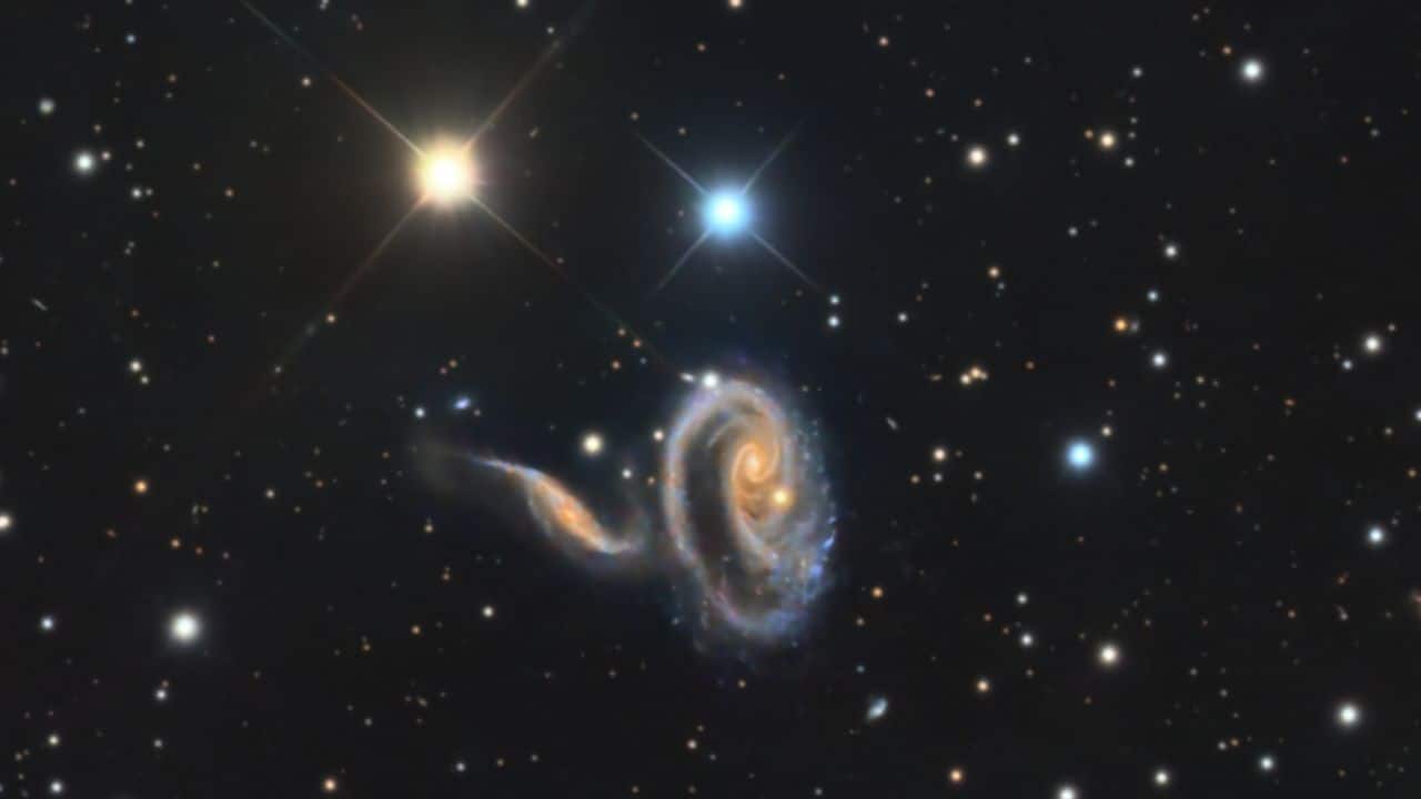 PECULIAR GALAXIES: This image shows Arp 273, two galaxies over 300 million light-years away, engaged in a cosmic dance. Their peculiar shape hints at the future collision between the Milky Way and Andromeda galaxies. PECULIAR GALAXIES: This image shows Arp 273, two galaxies over 300 million light-years away, engaged in a cosmic dance. Their peculiar shape hints at the future collision between the Milky Way and Andromeda galaxies.