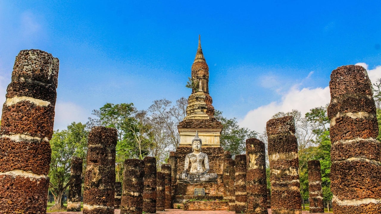 2. Sukhothai Historical Park While most tourists flock to Ayutthaya, Sukhothai offers a quieter yet equally mesmerizing peek into Thailand's past. Known as the birthplace of Thai civilization, this UNESCO World Heritage site is home to remarkable ruins, centuries-old temples, and stunning statues. It’s a place where history and beauty intertwine, making it a must-see for culture lovers. (Image: Canva)
