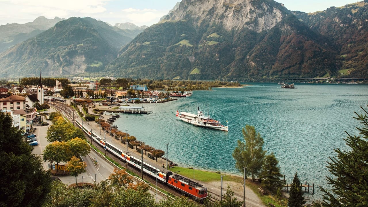 5. Lugano to Lucerne: Gotthard Panorama Express, Switzerland The Gotthard Panorama Express offers a seamless fusion of Swiss beauty—lake views, snow-capped peaks, and the charm of two iconic Swiss cities, Lugano and Lucerne. This journey is a serene escape through alpine meadows, making it one of Switzerland’s most scenic rail experiences. (Image: Switzerland Tourism)