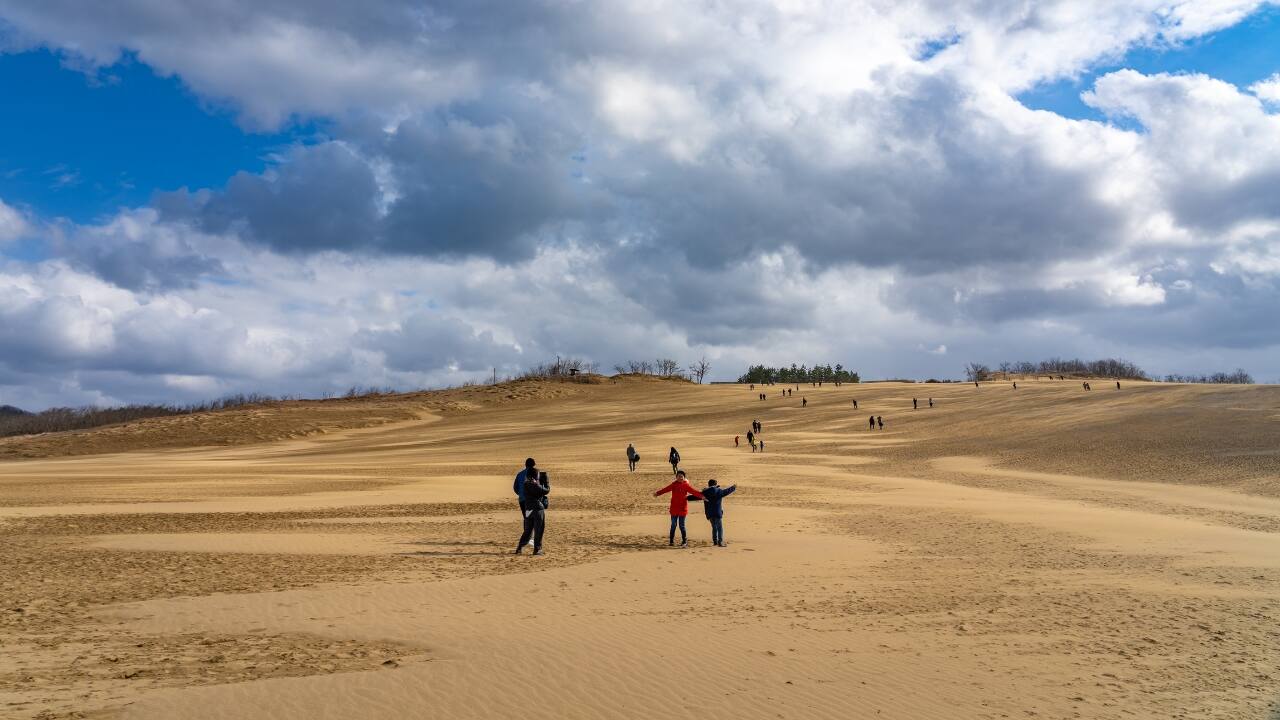 6. Tottori: Japan’s Desert-Like Landscape Tottori’s vast sand dunes offer a unique, almost otherworldly landscape. Tottori Sand Dunes Conan Park lets you experience camel rides, sandboarding, and the mesmerizing Dune Express, a train that takes you through the dunes. Tottori is also recognized as a “Dark Sky Place,” making it an ideal spot for stargazing. With clear, unpolluted skies, you can witness the beauty of the stars in one of Japan’s most peaceful regions. (Image: Canva)