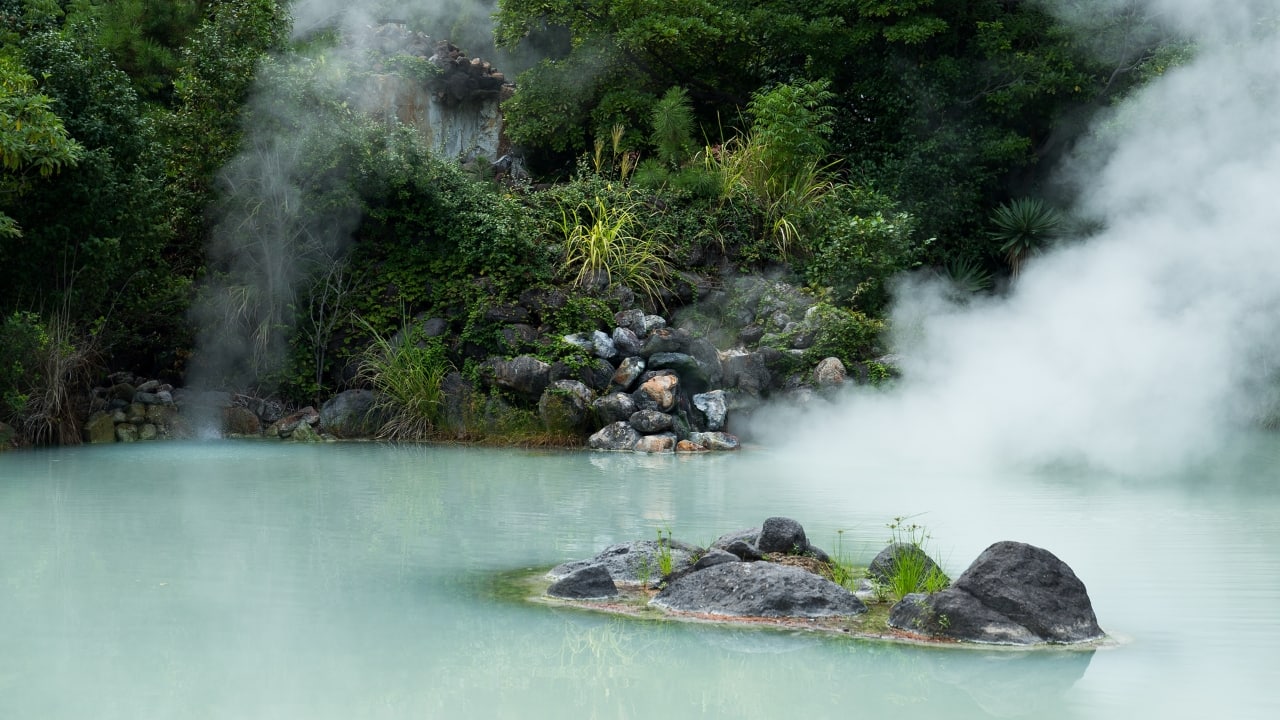 9. Beppu: The Hot Spring Capital of Japan Beppu is famous for its “Hells” — bubbling hot springs that come in vibrant colors and offer a unique view of the power of geothermal activity. The city also features sand and mud baths that provide a relaxing and rejuvenating experience. For food enthusiasts, Beppu is known for its hot spring-steamed dishes, which include steamed seafood, vegetables, and even eggs. With its vast array of hot spring experiences, Beppu is a must-visit for wellness seekers. (Image: Canva)