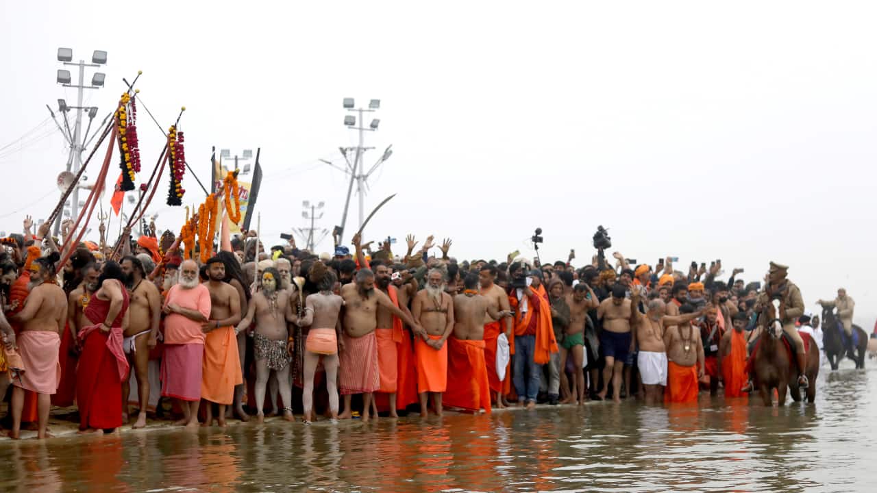 The Holy Dip at Sangam: Devotees take a sacred dip at the confluence of the Ganga, Yamuna, and Saraswati rivers, believed to cleanse sins and bring spiritual liberation. (Image: Sanjit Kumar)