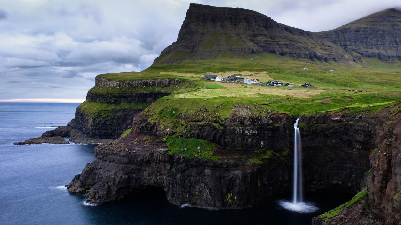 5. Faroe Islands With dramatic fjords, misty cliffs, and quaint villages, the Faroe Islands are a hidden gem in the North Atlantic. The absence of large crowds and its untouched landscapes make it an ideal escape for those wanting to disconnect. (Image: Canva)