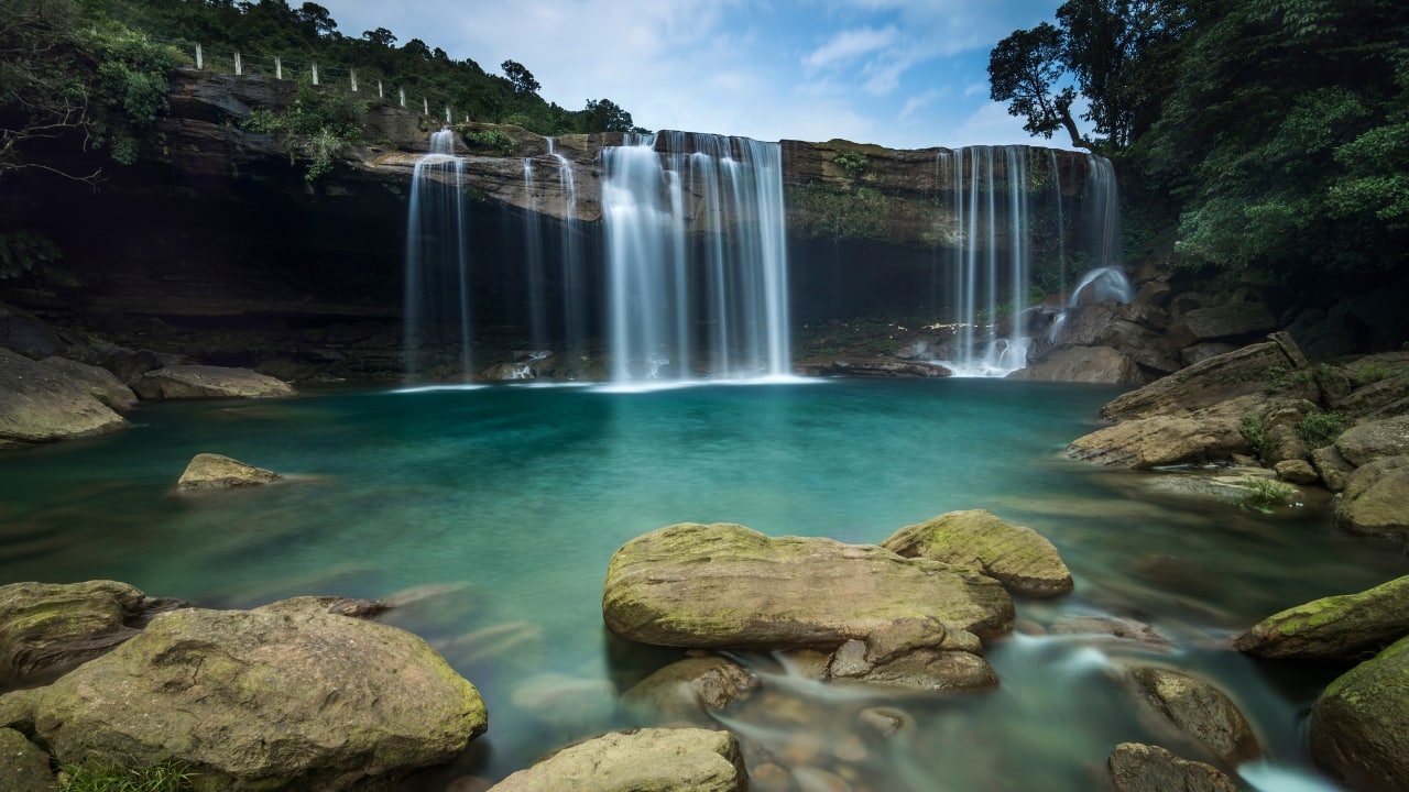 13. Meghalaya Known for its misty hills and breathtaking waterfalls, Meghalaya is one of India’s best-kept secrets. The Living Root Bridges, vibrant green valleys, and cascading waterfalls like Nohkalikai and Elephant Falls are perfect for creating dramatic and awe-inspiring shots. (Image: Canva)