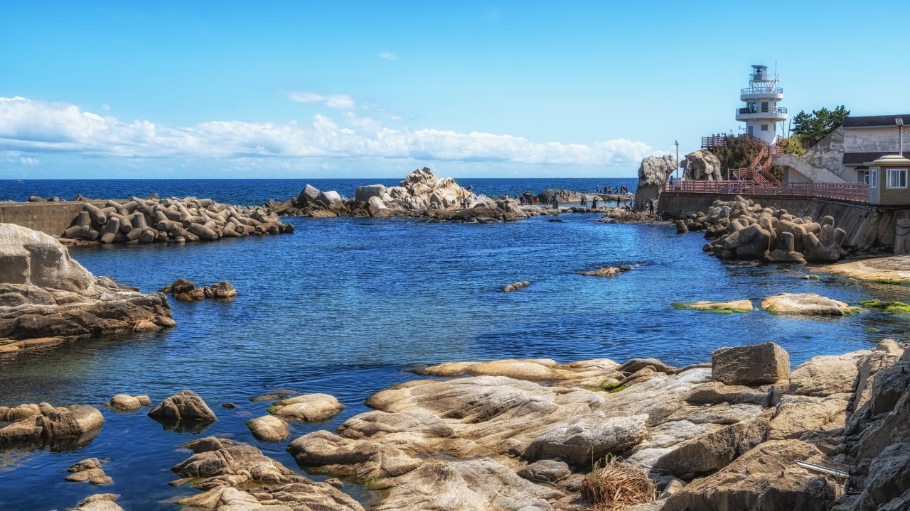 4. Jumunjin Beach – The Legendary Goblin Scene Jumunjin Beach is where one of the most iconic K-drama moments happened—Ji Eun-tak summoning Kim Shin for the first time in Goblin! This dreamy beach with its scenic breakwater is the perfect spot to recreate that unforgettable scene. Must-Do: Bring a red scarf, stand on the breakwater, and wait for your own Goblin to appear! (Image: Canva)
