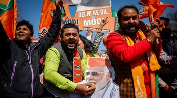 Bharatiya Janata Party (BJP) supporters celebrate outside the BJP state headquarters
