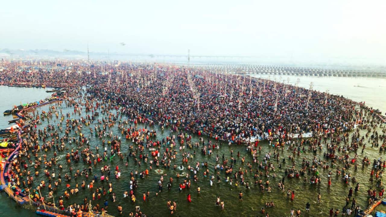 A large crowd of devotees gathers at the Sangam on Maghi Purnima, offering prayers and performing rituals while taking a holy dip in the sacred confluence during Maha Kumbh Mela 2025. (Image: PTI)