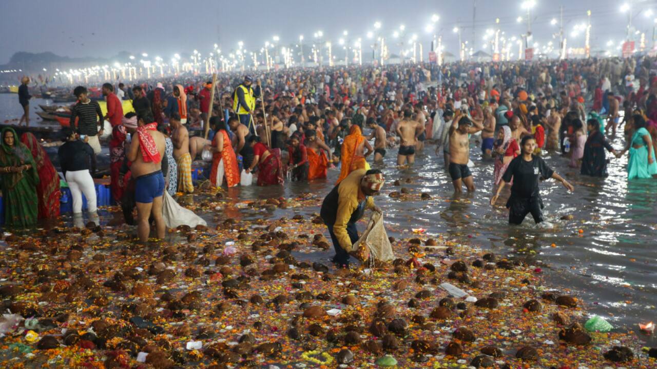 Devotees, young and old, stand waist-deep in the river, chanting prayers and performing rituals as the golden morning sun rises over the Maha Kumbh Mela in Prayagraj. (Image: PTI)