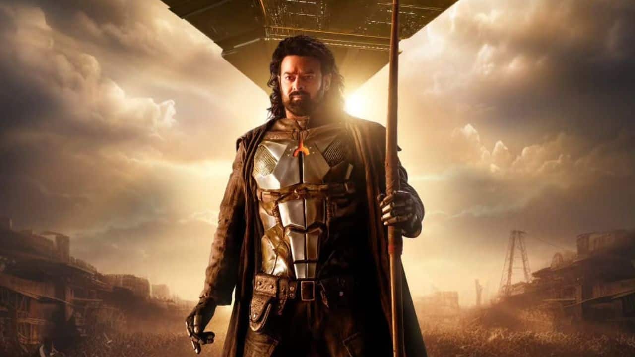 Prabhas' look in Kalki is nothing short of striking. He sports a rugged, intense appearance that perfectly matches the film’s action-driven, period setting. His character is seen in traditional warrior attire, which adds a fierce and battle-ready vibe. With a chiseled, strong build and a focused, determined expression, Prabhas carries a raw, powerful presence throughout the film. His hairstyle and makeup reflect the era, further enhancing his character’s authenticity and depth. Fans are sure to be captivated by his commanding presence, which showcases his dedication to bringing the complex role to life.