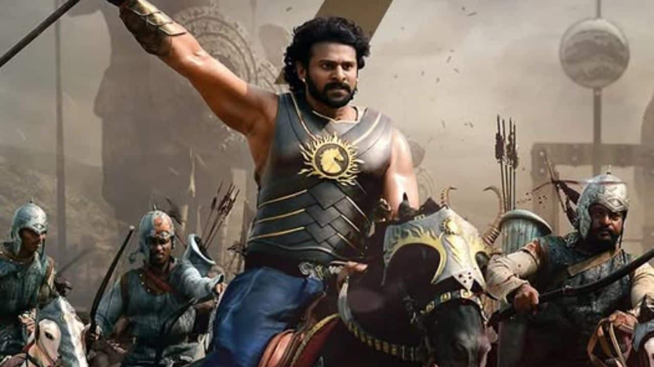 In Baahubali, Prabhas showcased two distinct looks—one as a fierce warrior and the other as a majestic king. As Amarendra Baahubali, he exuded royalty in rich armor, a regal crown, and a commanding presence. As Mahendra Baahubali, he embraced a rugged warrior avatar, with unkempt hair and battle scars, perfectly embodying both power and legacy.