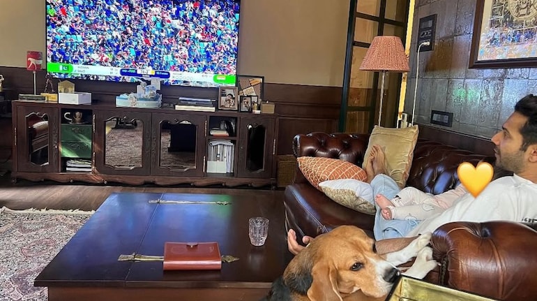 On Sunday, Varun Dhawan shared a heartfelt moment on Instagram, posting a picture of himself enjoying the India-Pakistan match with his daughter Lara and their pet dog, Joey.