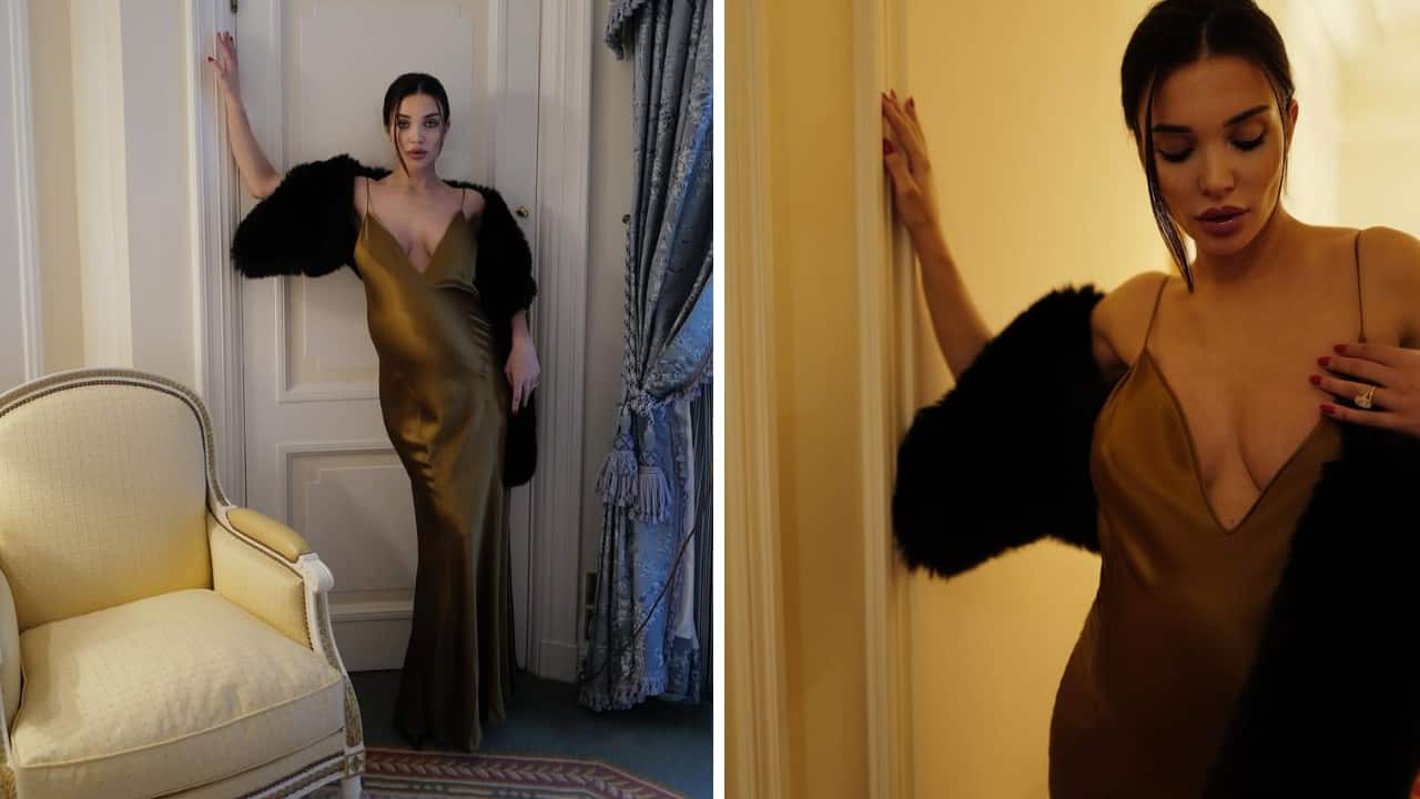 Amy Jackson styles her baby bump in a rich satin dress, adds drama with a black cape