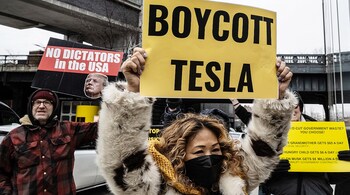 Protesters against Elon Musk's actions in the Trump administration outside a Tesla showroom in New York on Feb. 15. Photographer: Stephanie Keith/Bloomberg