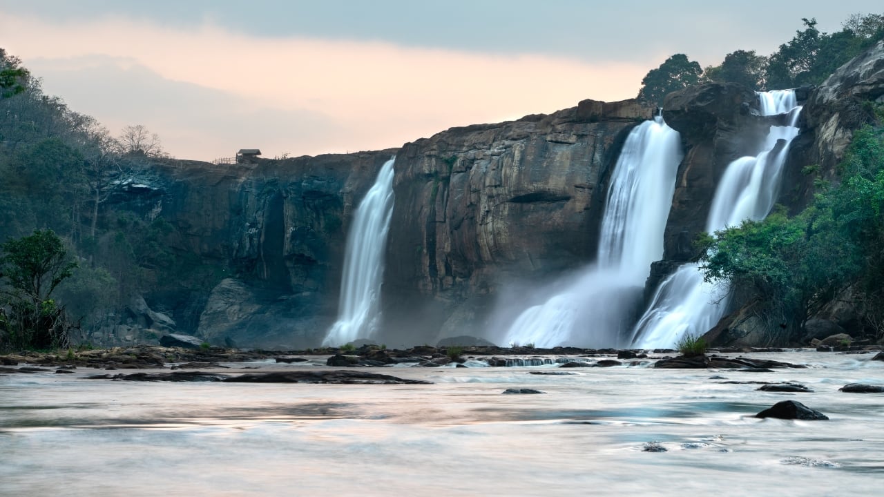5. Athirappilly, Kerala – Kerala’s Own Niagara Falls Watching a waterfall in full flow is hypnotic, and Athirappilly captures that charm. This is Kerala's biggest waterfall, standing eighty feet tall, and during the monsoon, it is rather beastly. The sight, the sound, the pure force of the water—its essence is unadulterated. See rare species, hike the verdant rainforest, and simply relax by the falls, feeling the mist on your cheek. This kind of place causes one to forget all else. (Image: Canva) 5. Athirappilly, Kerala – Kerala’s Own Niagara Falls Watching a waterfall in full flow is hypnotic, and Athirappilly captures that charm. This is Kerala's biggest waterfall, standing eighty feet tall, and during the monsoon, it is rather beastly. The sight, the sound, the pure force of the water—its essence is unadulterated. See rare species, hike the verdant rainforest, and simply relax by the falls, feeling the mist on your cheek. This kind of place causes one to forget all else. (Image: Canva)