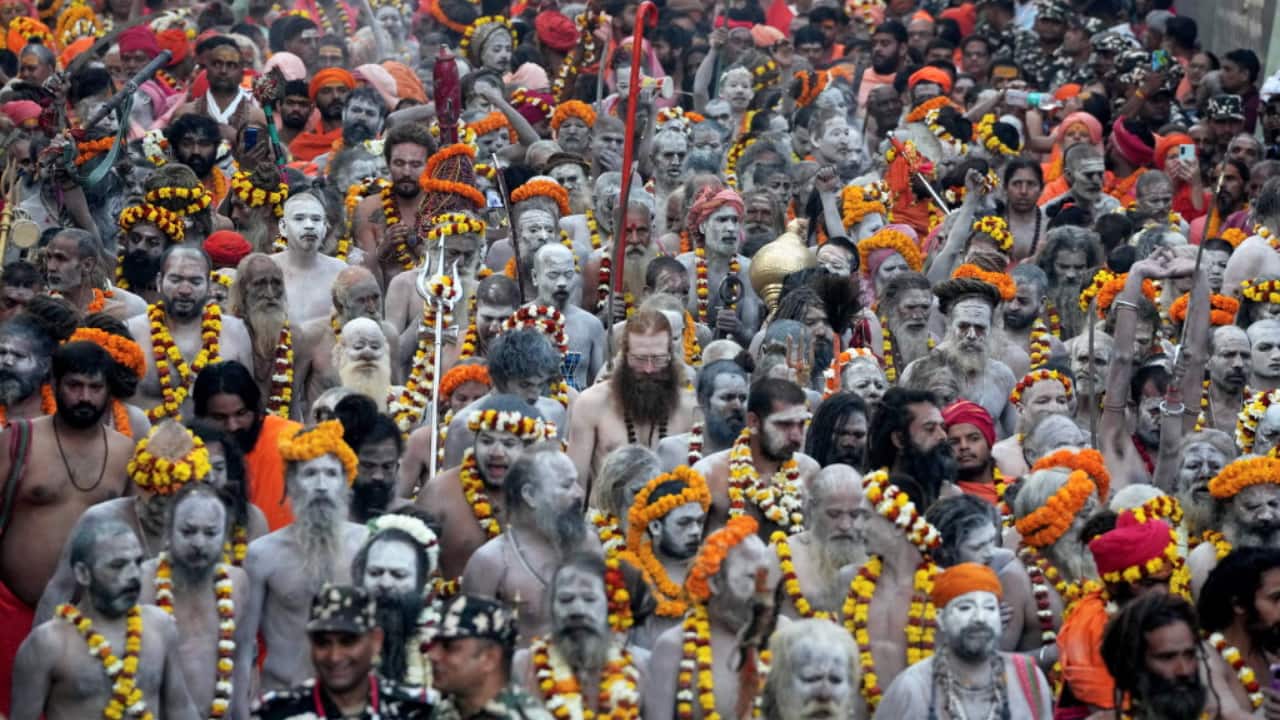 8. Varanasi | Naga sadhus, covered in sacred ash, march towards Kashi Vishwanath temple, chanting hymns and paying homage to Lord Shiva on Maha Shivratri in Varanasi. (Image: PTI)