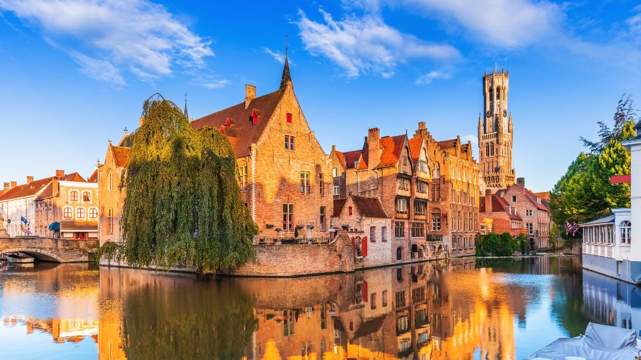 2. Skip Paris and Head for Bruges. Though everyone thinks of Paris as the ideal romantic location, it can seem more touristy than ideal. See Bruges, Belgium, for an equally magical experience. Bruges seems like entering a fairy tale with its medieval charm, canals meandering through cobbled alleyways, and small cafes. Couples looking for tranquility and romance will find this lovely city perfect whether they are wandering along calm canals or savoring hot chocolate. (Image: Canva)