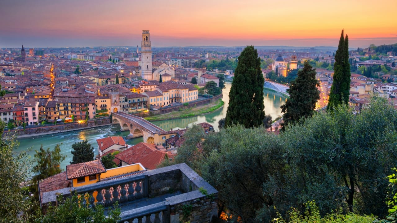 5. Say Goodbye to Venice; Find Verona. While Venice is charming, the crowds can be very taxing. Rather, travel to Verona, Italy—the city where Romeo and Juliet lived. Here, the romance feels real. Wander through little lanes, stop at the well-known Juliet's Balcony, and savor gelato while appreciating the medieval vibe of the city. Couples who wish to unwind and enjoy each other's company will find Verona ideal because of its slower pace. (Image: Canva)
