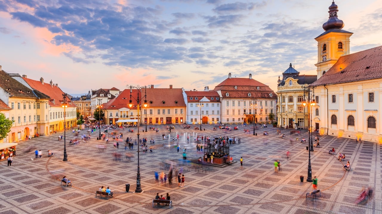 4. Sibiu, Romania – Transylvania’s Best-Kept Secret With its baroque squares, eye-shaped rooftops, and cobbled streets, Sibiu is both mysterious and charming. This Romanian gem is perfect for capturing Gothic beauty and quirky local traditions. (Image: Canva)