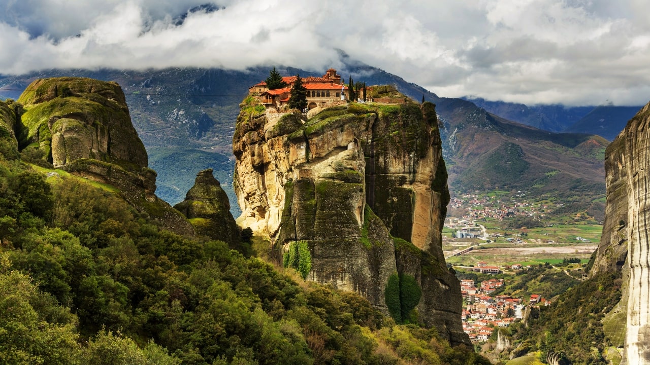 8. Meteora, Greece – Monasteries in the Sky Perched atop massive rock pillars, Meteora’s monasteries seem to float in the clouds. Capture epic drone shots and tell the story of one of Greece’s most mystical landscapes. It’s the ultimate spot for spiritual and adventure vloggers. (Image: Canva)