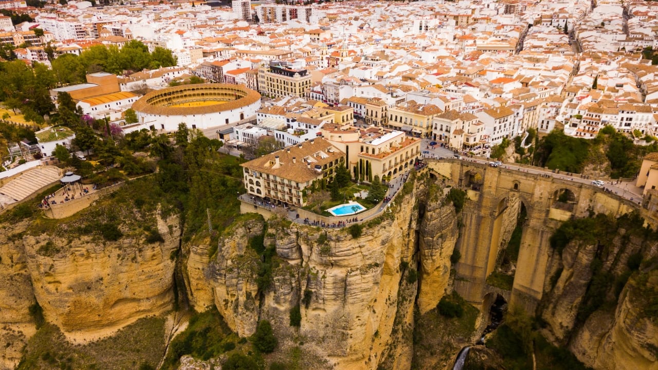 12. Ronda, Spain – A City Suspended in Time This Andalusian wonder sits dramatically atop a massive gorge, connected by the famous Puente Nuevo Bridge. Capture breathtaking shots of the cliffs, explore Spain’s oldest bullring, and experience authentic flamenco in this picturesque town. (Image: Canva)