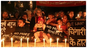 Women and children during a candle light vigil to pay homage to the victims of the Bhopal Gas Tragedy. (Courtesy: PTI file photo)