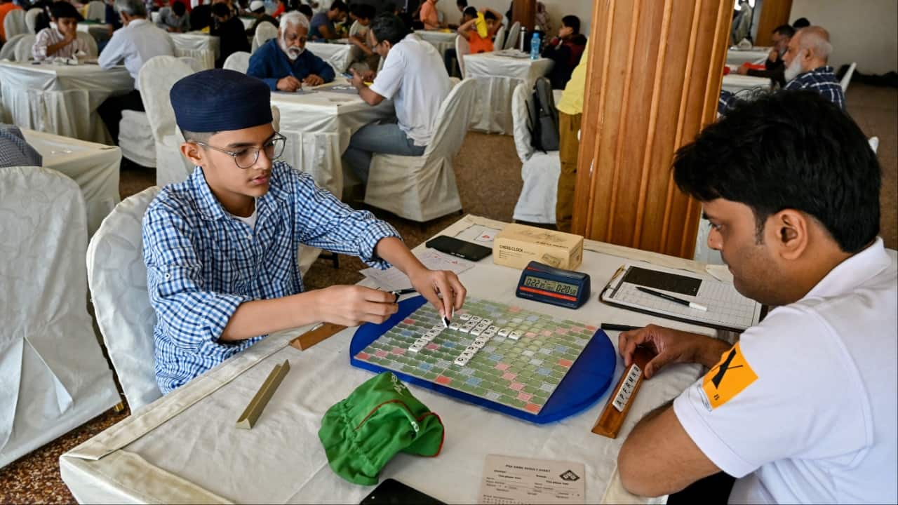 Pakistani prodigy Bilal Asher (L), world under-14 Scrabble champion, competes against professional Scrabble coach Waseem Khatri during an event organised by the Pakistan Scrabble Association (PSA) at the Beach Luxury hotel in Karachi. (Image credit: AFP)