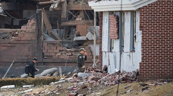 FILE PHOTO: Officials inspect an area with damaged buildings after South Korea's Air Force said that Mk82 bombs fell from a KF-16 jet outside the shooting range during joint live-fire exercises near the demilitarized zone separating two Koreas in Pocheon, South Korea, March 6, 2025. REUTERS/Kim Hong-Ji/File Photo