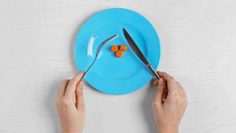 Symptoms of anorexia nervosa: Symptoms of anorexia include fatigue, irritability, cold intolerance, and more. Reckless and harmful diets may lead to multiple health issues, such as extremely low body mass, heart problems, and muscle wasting (Image: Canva)