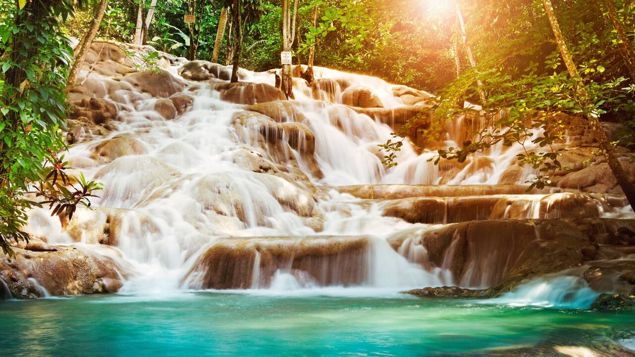 9. Jamaica – Caribbean Bliss Visa Policy: Visa-free for up to 30 days Jamaica is a Caribbean paradise with reggae music, scenic waterfalls, and sandy beaches. Visit Dunn’s River Falls, swim in the Blue Lagoon, or enjoy the vibrant streets of Kingston. Budget Breakdown: Flights: Rs 50,000 Stay: Budget hotels Rs 2,000 per night Daily expenses: Rs 3,000 Travel Tip: Eat at local jerk shacks for authentic and budget-friendly meals. (Image: Canva)