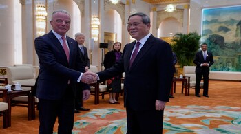 Chinese Premier Li Qiang greets Boeing Global Senior VP Brendan Nelson from a delegation led by U.S. Senator Steve Daines before a meeting held in the Fujian Room at the Great Hall of the People in Beijing