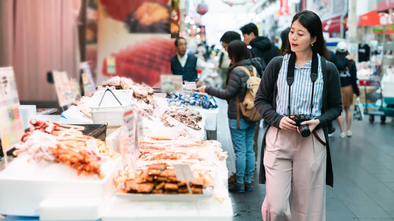 3. Savor Every Bite at Kuromon Ichiba Market Love food? You’ll love Kuromon Ichiba. Known as “Osaka’s Kitchen,” this bustling market is a paradise for food lovers. Try grilled seafood, fresh sushi, and even melt-in-your-mouth wagyu beef—all freshly made and full of flavor. (Image: Canva)