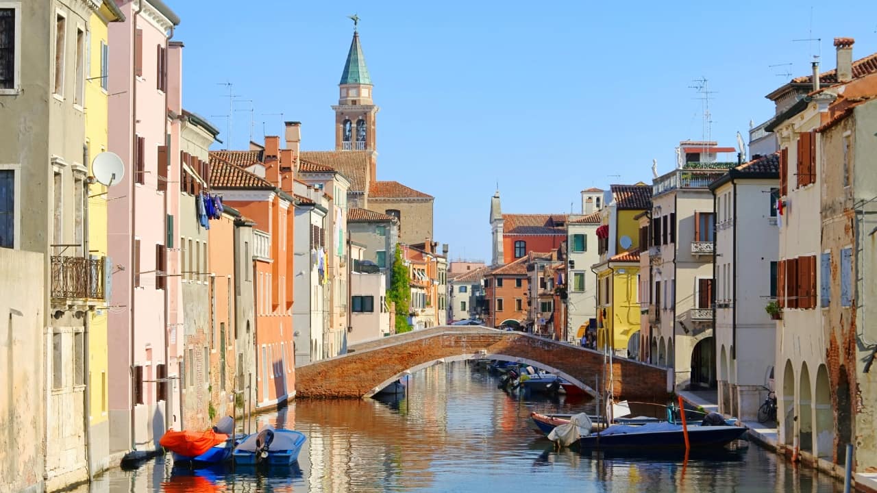 1. Instead of Venice, Visit Chioggia Skip the tourist crush of Venice and head to Chioggia, a charming fishing town in the Venetian Lagoon. With its winding canals, colorful boats, and bustling seafood markets, Chioggia delivers the magic of Venice—without the crowds. Stroll the Corso del Popolo or relax at Sottomarina Beach for a perfect mix of culture and coastal beauty. (Image: Canva) 1. Instead of Venice, Visit Chioggia Skip the tourist crush of Venice and head to Chioggia, a charming fishing town in the Venetian Lagoon. With its winding canals, colorful boats, and bustling seafood markets, Chioggia delivers the magic of Venice—without the crowds. Stroll the Corso del Popolo or relax at Sottomarina Beach for a perfect mix of culture and coastal beauty. (Image: Canva)
