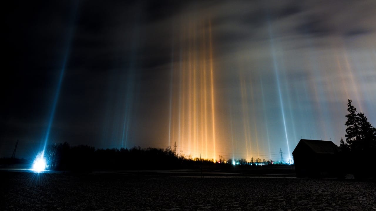 7. Light Pillars – Vertical Beams of Light, Arctic Regions When temperatures plummet in the Arctic, the sky lights up with shimmering, vertical beams that seem to stretch toward the heavens. Known as light pillars, these glowing columns form when light reflects off ice crystals floating in the air. This dazzling illusion is most often seen during cold winter nights, creating a celestial display that feels straight out of a fantasy world. (Image: Canva)