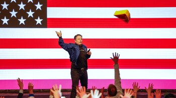 Elon Musk tosses a cheesehead during a town hall Sunday, March 30, 2025, in Green Bay.