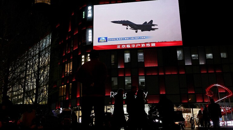 A military aircraft is seen on a giant screen showing news footage about joint army, navy, air and rocket forces drills around Taiwan by the Chinese People's Liberation Army (PLA), outside a shopping mall in Beijing, China (File image)