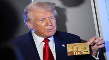 US President Donald Trump holds "The Trump Card" onboard Air Force One en route to Miami, Florida.