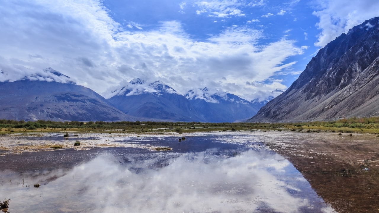 2. Panamik – Hot Springs at the Edge of Nowhere This sleepy Nubra Valley village surprises with natural hot sulfur springs and views of the Siachen Glacier. A long soak here, under wide blue skies, feels like a secret only a few ever discover. (Image: Canva) 2. Panamik – Hot Springs at the Edge of Nowhere This sleepy Nubra Valley village surprises with natural hot sulfur springs and views of the Siachen Glacier. A long soak here, under wide blue skies, feels like a secret only a few ever discover. (Image: Canva)