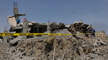 File photo of a Houthi security officer inspects the debris of a destroyed building reportedly hit by US airstrikes in Sanaa, Yemen.