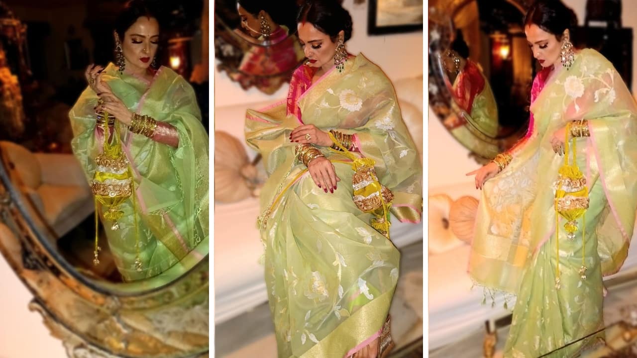 Rekha wore a luxurious Banarasi Kora saree, featuring delicate floral motifs and an elegant border in gold and pink. She styled it with a fuchsia pink blouse that added a vibrant pop of colour (Images: @manishmalhotra05/Instagram)
