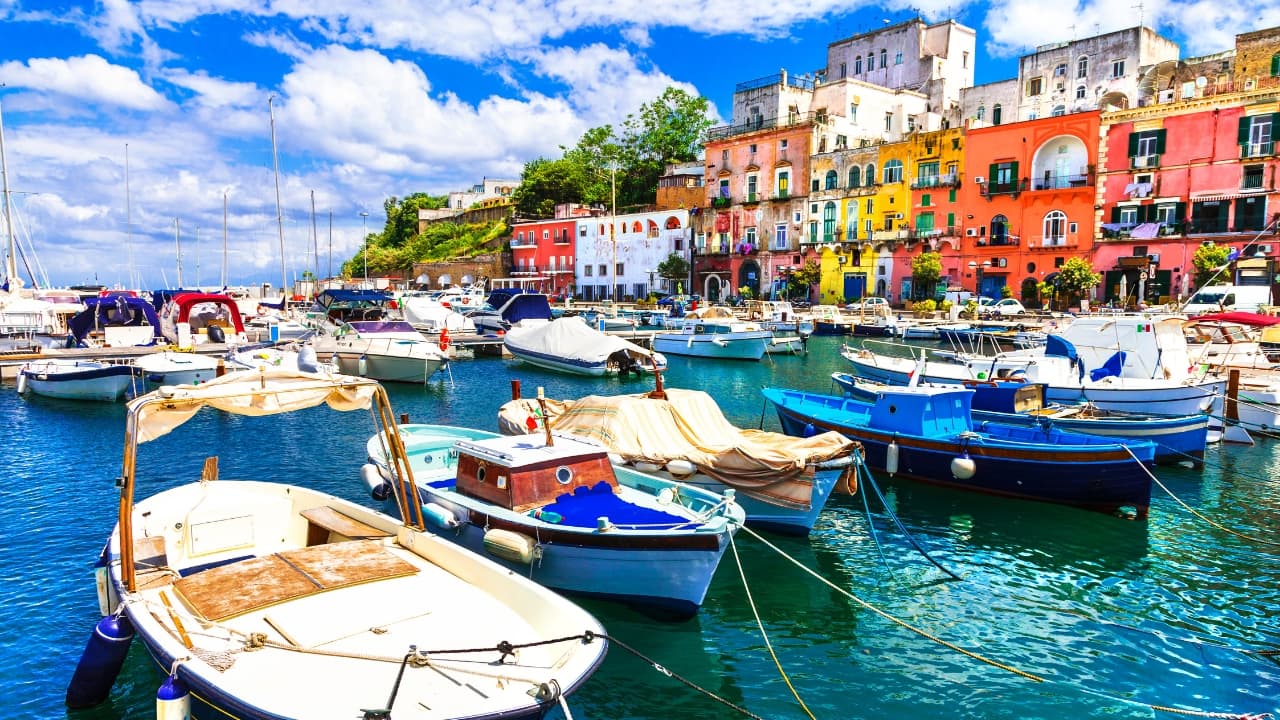 5. Procida, Italy Imagine a coastal town where every house is a different shade of pastel, where the sea sparkles like sapphire and the cliffs rise above in a stunning contrast. That’s Procida, Italy—a hidden gem in the Gulf of Naples. Its charming, colorful buildings create a stunning visual harmony that’s perfect for a peaceful getaway. Whether you're strolling through the harbor or soaking in the sunset, this is a place that will steal your heart. (Image: Canva)