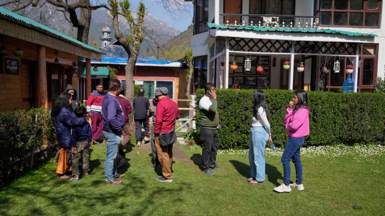 Tourists contact loved ones after militants opened fire near Pahalgam, Kashmir, on April 23, 2025. (Image: PTI)