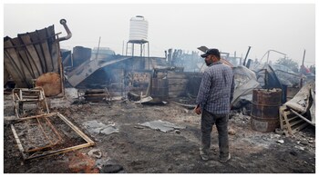 A Palestinian inspects the damage after an attack by Israeli settlers, in Sinjil, near Ramallah, in the Israeli-occupied West Bank. (Courtesy: Reuters photo)