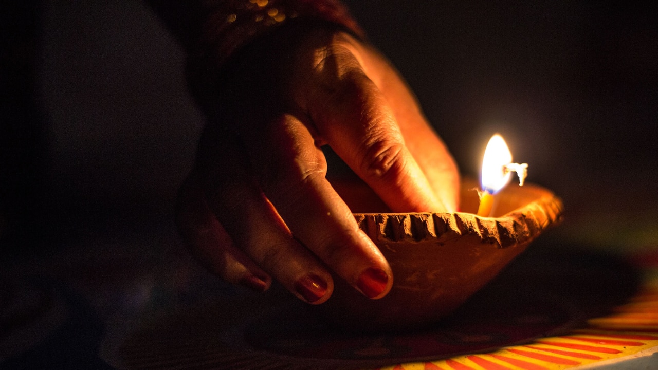 1. Light a Diya Near Tulsi Plant: Tulsi is sacred in Hinduism. Lighting a ghee diya near the Tulsi plant on Mohini Ekadashi brings wealth, happiness, and peace at home. It also pleases Maa Lakshmi, who blesses the household with abundance. (Image: Canva)