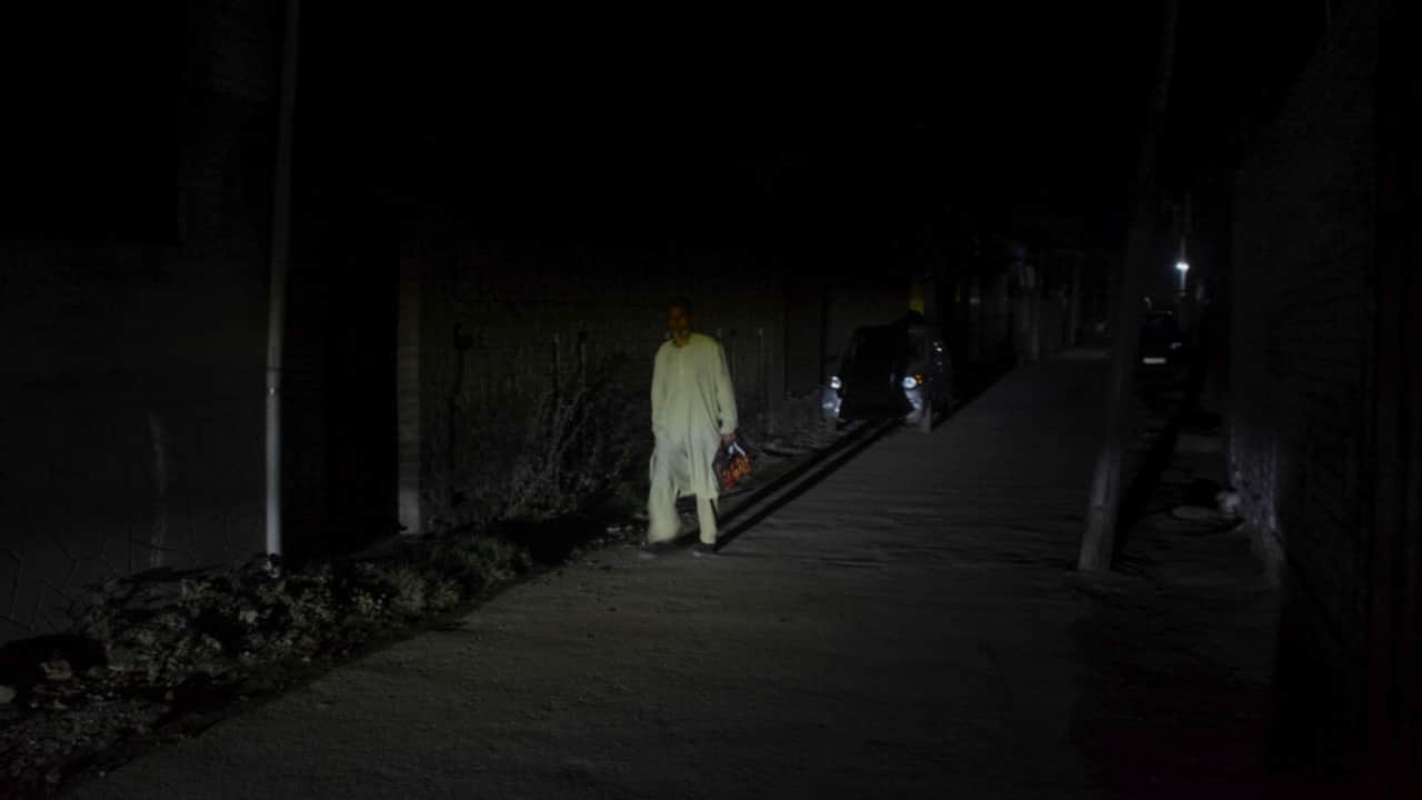 Srinagar: A pedestrian on a road during blackout.