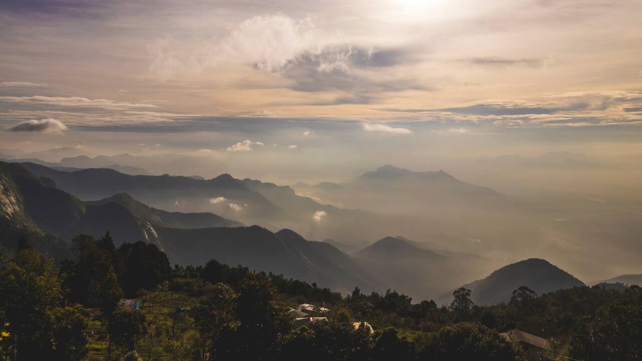 The Southern stretch of the Western and Eastern Ghats is a sanctuary of rolling hills, dense forests, and whispering winds. While the spotlight often falls on popular escapes like Ooty or Munnar, South India hides a treasure trove of hill stations that remain untouched by mass tourism. These lesser-known retreats are perfect for travelers who prefer winding trails over crowded viewpoints and quiet sunsets over noisy marketplaces. Here’s a list of 10 hidden hill stations in South India—quiet, charming, and brimming with soul. (Image: Canva)