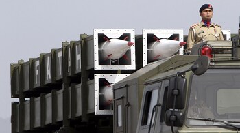 A Pakistani army soldier stands atop a military vehicle carrying Fatah missile (Guided Multi Launch Rocket System) during the Pakistan Day parade in Islamabad on March 23, 2022. (Photo by Ghulam Rasool / AFP)
