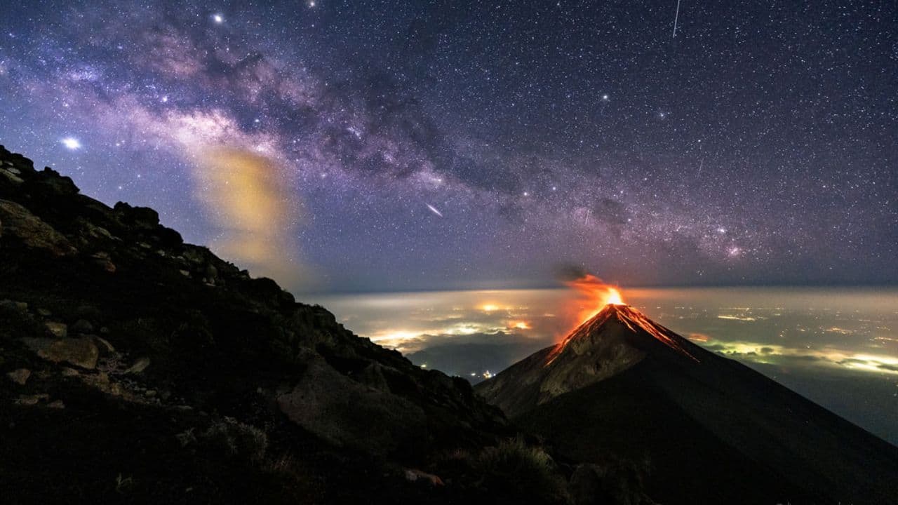 Milky Way Over a Volcano: A stunning image of the Milky Way arching over a volcanic landscape, captured by NASA's Astronomy Picture of the Day. (Image: Canva)