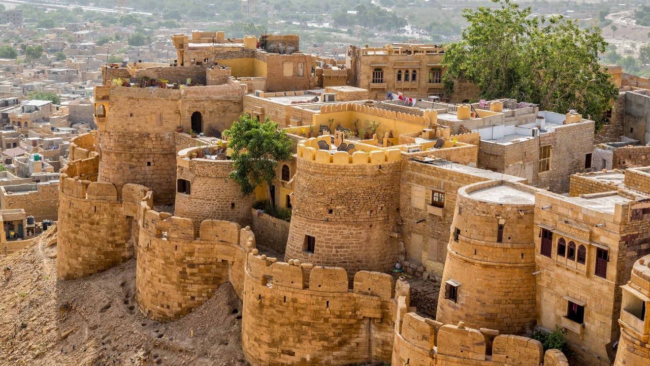 4. Jaisalmer Fort, Rajasthan: The Golden Fortress That Defied the Desert and the Empire More city than citadel, Jaisalmer Fort is alive—with people, stories, and trade. Its golden sandstone glows at sunrise and sunset, but beneath its beauty lies a strategic genius. Nestled deep in the Thar Desert and backed by powerful local alliances, the fort kept the British at bay. Stroll through its winding lanes, past bustling bazaars and ancient temples, and you’ll feel like you’re walking through a time capsule. (Image: Canva) 4. Jaisalmer Fort, Rajasthan: The Golden Fortress That Defied the Desert and the Empire More city than citadel, Jaisalmer Fort is alive—with people, stories, and trade. Its golden sandstone glows at sunrise and sunset, but beneath its beauty lies a strategic genius. Nestled deep in the Thar Desert and backed by powerful local alliances, the fort kept the British at bay. Stroll through its winding lanes, past bustling bazaars and ancient temples, and you’ll feel like you’re walking through a time capsule. (Image: Canva)